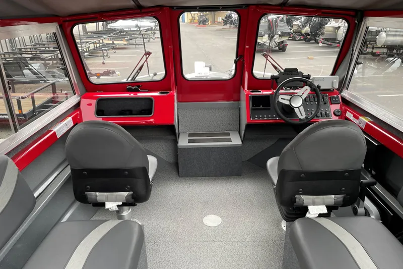 Slide: The Image of Interior of 2024 Spartan 200 Astoria boat with red dashboard and gray seating. - 7
