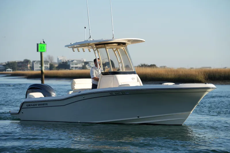 Slide: The Image of 2023 Grady-White Fisherman 216 boat cruising on calm waters near a channel marker. - 18