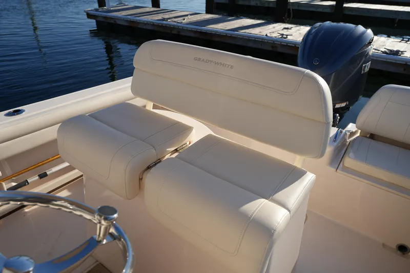 Slide: The Image of 2023 Grady-White Fisherman 216 boat interior with cushioned seating and steering wheel. - 28