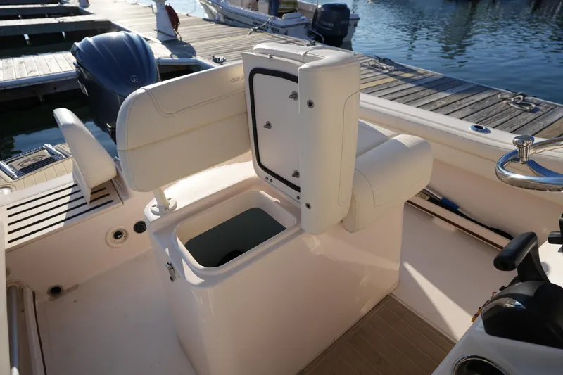 Slide: The Image of 2023 Grady-White Fisherman 216 boat interior with open storage compartment at dock. - 29
