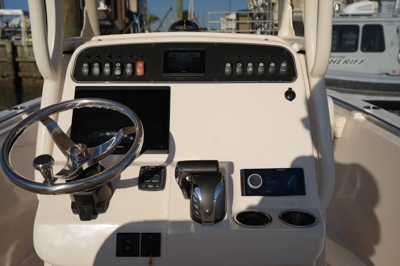Slide: The Image of 2023 Grady-White Fisherman 216 boat dashboard with steering wheel and controls. - 31