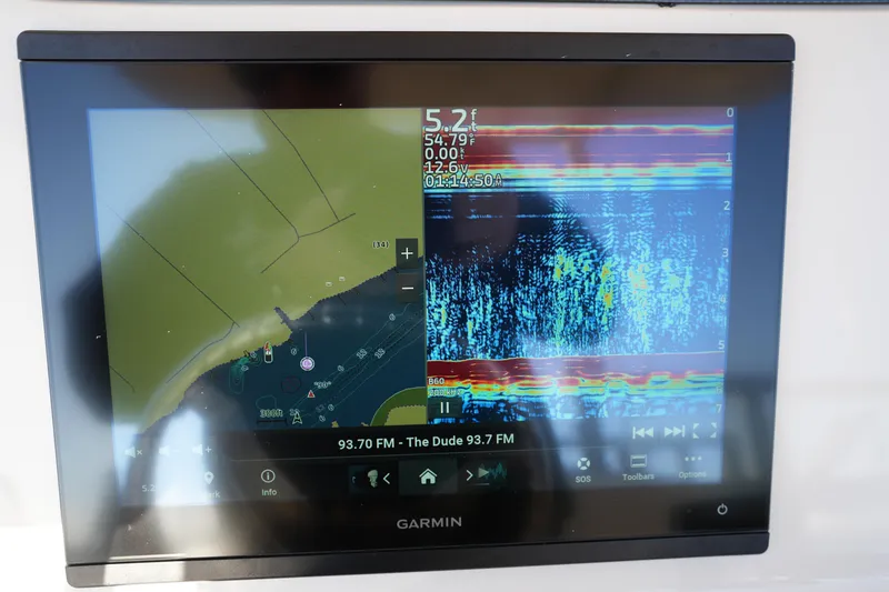 Slide: The Image of Garmin marine display on 2023 Grady-White Fisherman 216 showing navigation and sonar data. - 34
