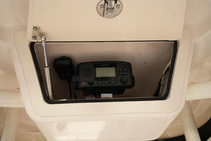 Slide: The Image of 2023 Grady-White Fisherman 216 boat radio compartment with Garmin device. - 39