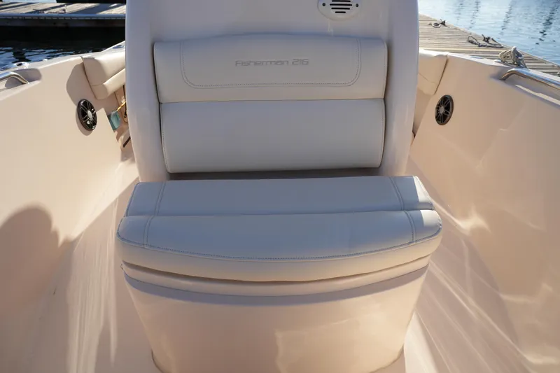 Slide: The Image of 2023 Grady-White Fisherman 216 boat seat, white upholstery, dockside view. - 41