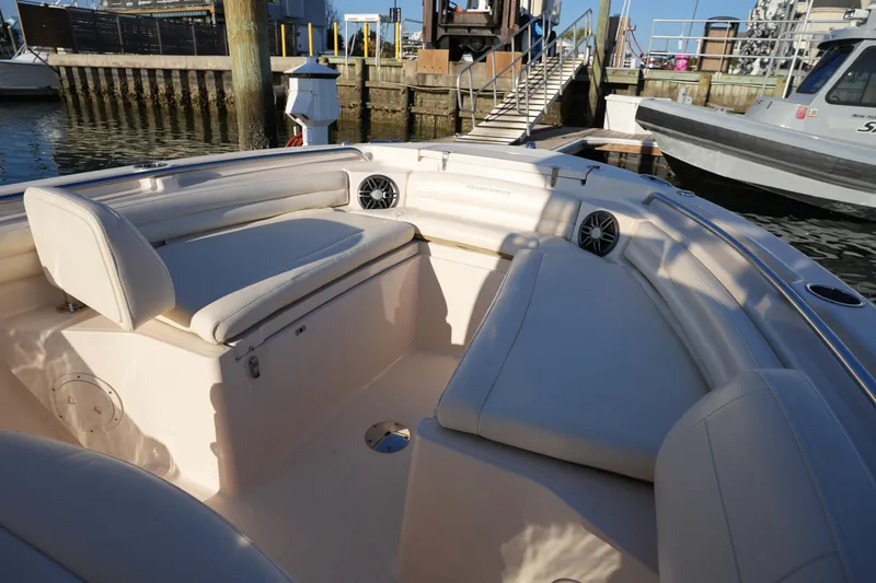 Slide: The Image of 2023 Grady-White Fisherman 216 boat interior with cushioned seating at dock. - 45
