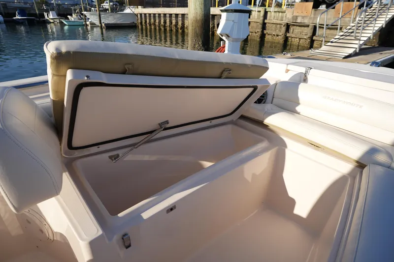 Slide: The Image of 2023 Grady-White Fisherman 216 boat with open storage compartment at marina. - 46