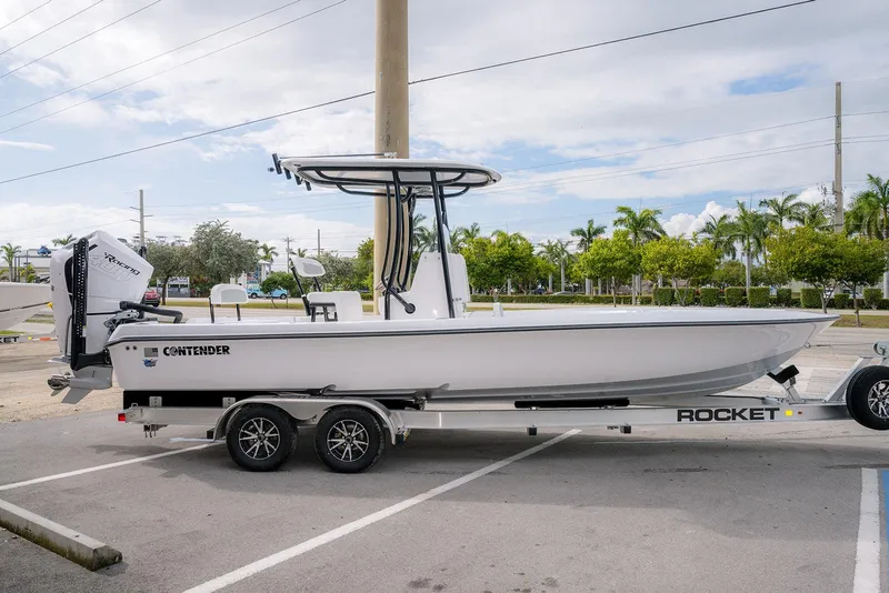 The Image of 2026 Contender 26 Bay boat on trailer in parking lot, side view. - 0