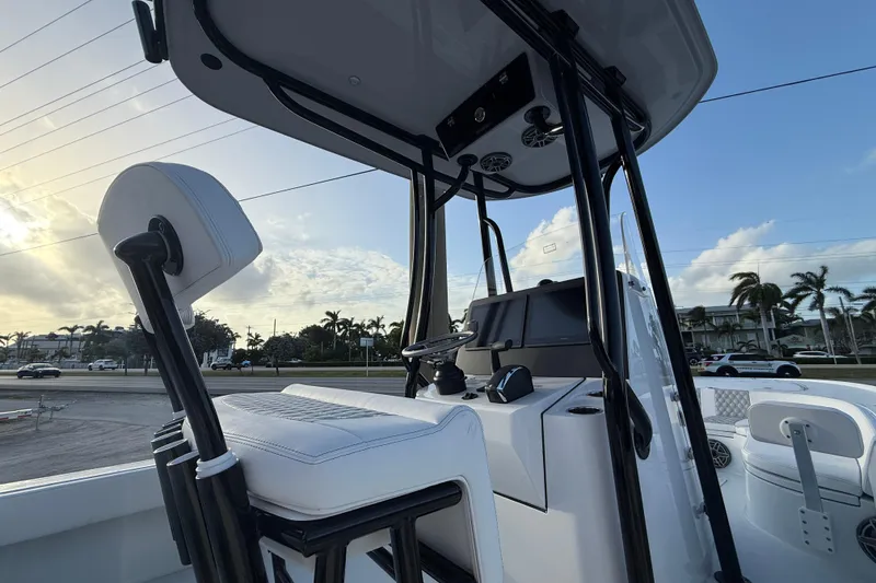 Slide: The Image of 2026 Contender 26 Bay boat console with steering wheel and controls. - 13