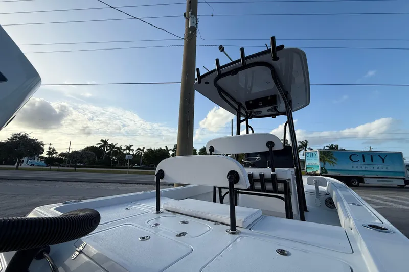 Slide: The Image of 2026 Contender 26 Bay boat on trailer outside dealership, ready for sale or trade. - 15
