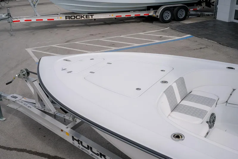 Slide: The Image of 2026 Contender 26 Bay boat on trailer, featuring sleek white design and cushioned seating. - 17