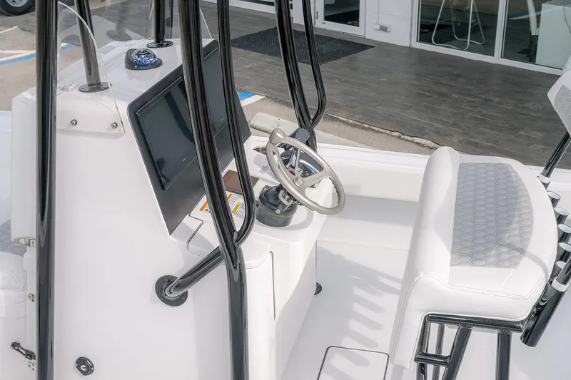 Slide: The Image of 2026 Contender 26 Bay boat interior with steering wheel and modern console. - 19