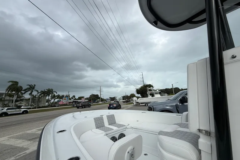 Slide: The Image of 2026 Contender 26 Bay boat interior with white seating and speaker system. - 20