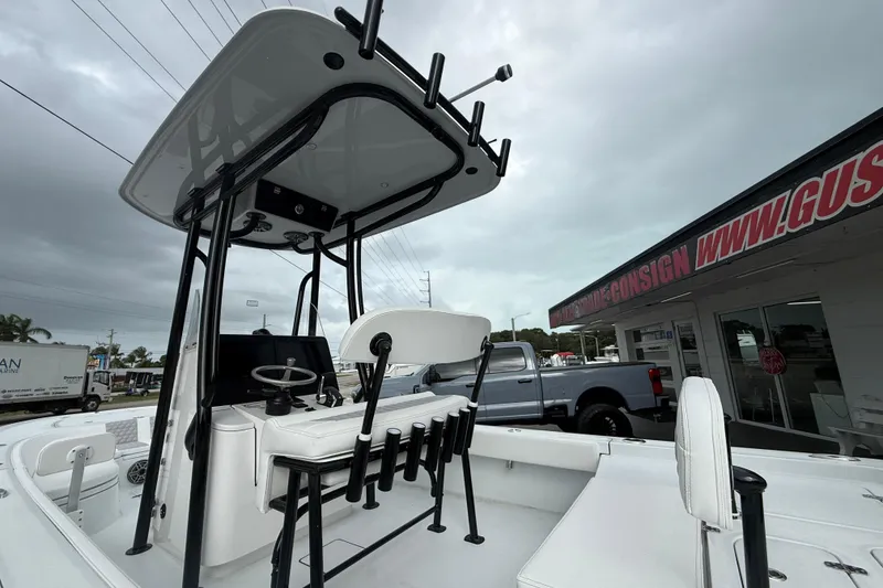 Slide: The Image of 2026 Contender 26 Bay boat interior with modern console and seating at a dealership. - 21