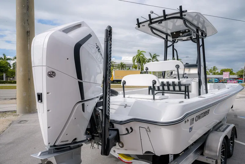 Slide: The Image of 2026 Contender 26 Bay boat with powerful outboard motor, parked on a trailer. - 3