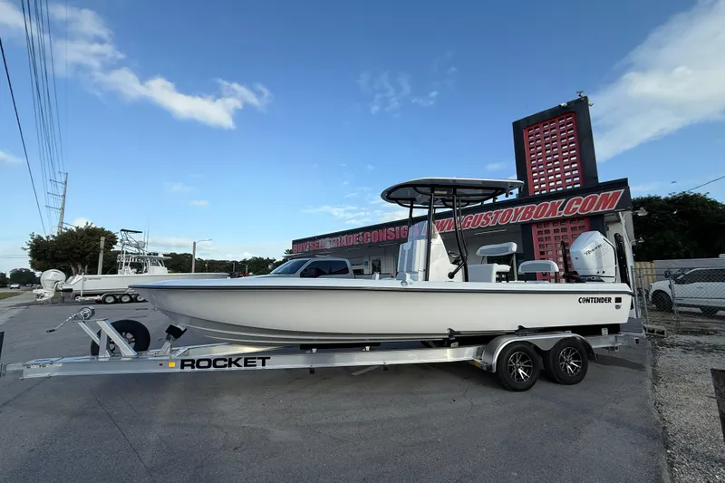 Slide: The Image of 2026 Contender 26 Bay boat on trailer outside dealership. - 6
