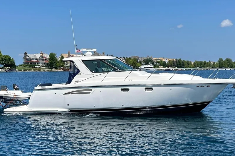 The Image of 2005 Tiara Yachts 3600 Sovran cruising on a serene lake with scenic shoreline. - 0