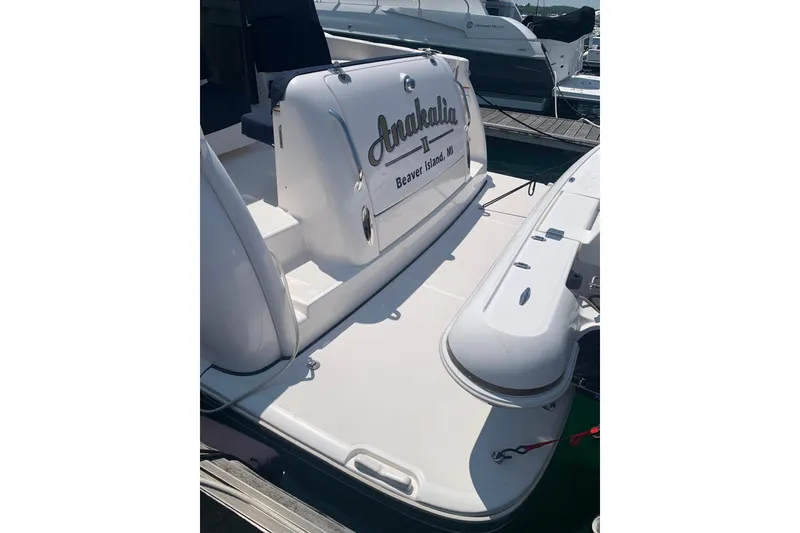 Slide: The Image of 2005 Tiara Yachts 3600 Sovran at dock, featuring rear deck and boat name. - 11