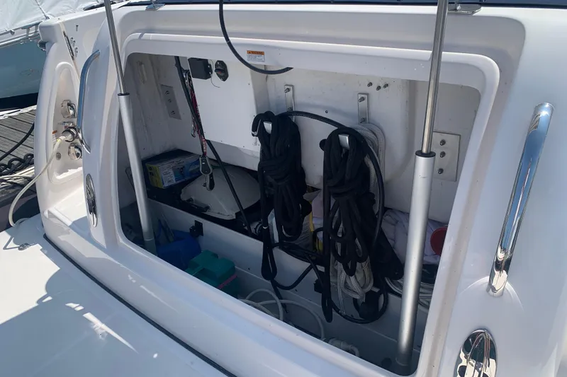 Slide: The Image of Storage compartment on a 2005 Tiara Yachts 3600 Sovran, featuring ropes and equipment. - 12
