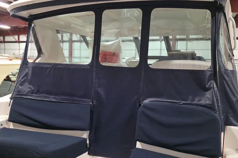 Slide: The Image of 2005 Tiara Yachts 3600 Sovran with blue canvas enclosure in a storage facility. - 14