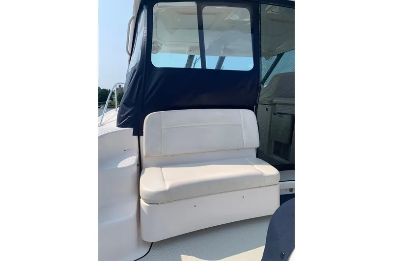 Slide: The Image of 2005 Tiara Yachts 3600 Sovran seating area with cushioned bench and window view. - 16