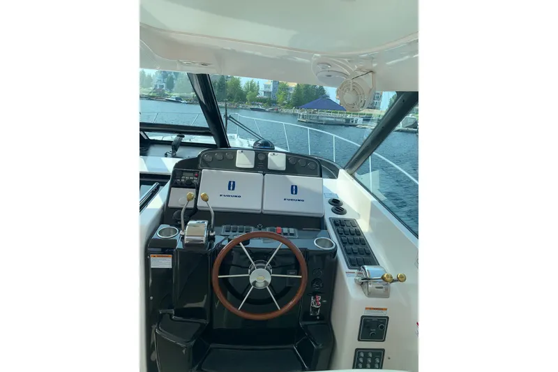 Slide: The Image of Helm of 2005 Tiara Yachts 3600 Sovran with navigation equipment and steering wheel. - 17