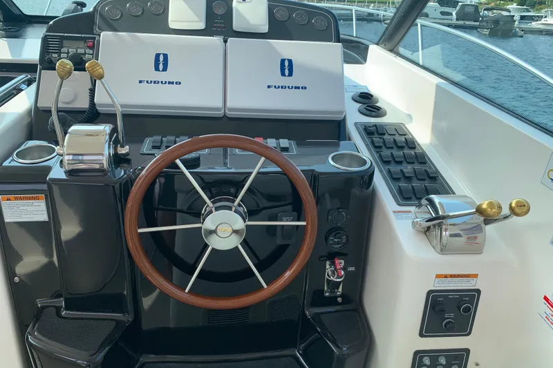 Slide: The Image of 2005 Tiara Yachts 3600 Sovran helm with Furuno navigation and wooden steering wheel. - 18