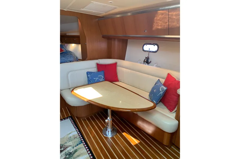 Slide: The Image of 2005 Tiara Yachts 3600 Sovran interior with cozy seating and elegant wooden table. - 25