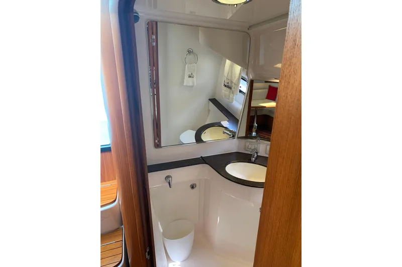 Slide: The Image of 2005 Tiara Yachts 3600 Sovran bathroom with mirror, sink, and wooden accents. - 29