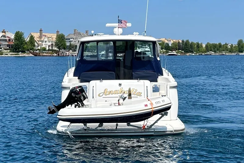 Slide: The Image of 2005 Tiara Yachts 3600 Sovran cruising on a sunny day near waterfront homes. - 3
