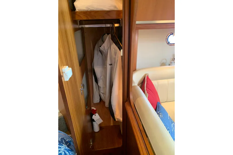 Slide: The Image of 2005 Tiara Yachts 3600 Sovran interior closet with jackets and seating area. - 31