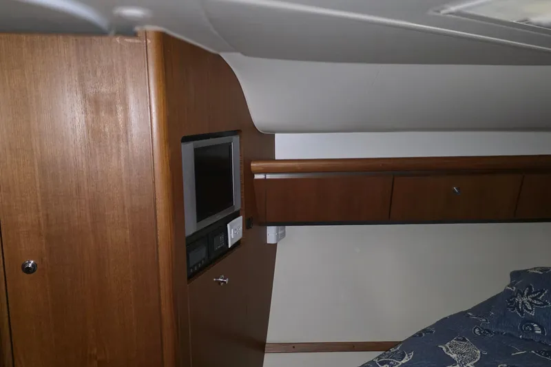 Slide: The Image of 2005 Tiara Yachts 3600 Sovran cabin interior with wood paneling and built-in TV. - 37
