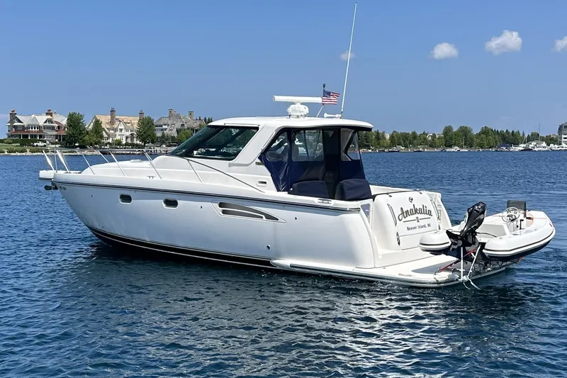 Slide: The Image of 2005 Tiara Yachts 3600 Sovran cruising on a sunny day near a coastal town. - 4