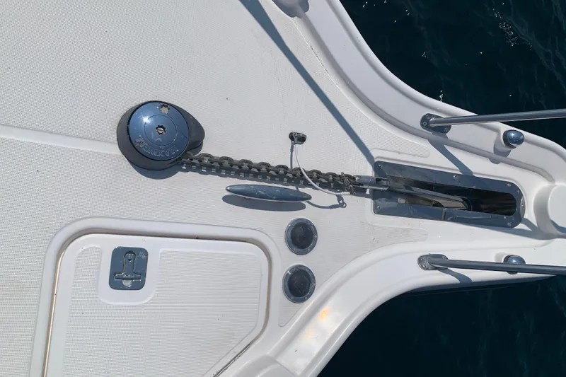 Slide: The Image of 2005 Tiara Yachts 3600 Sovran anchor system on deck, featuring windlass and chain. - 44