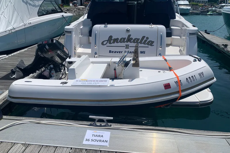 Slide: The Image of 2005 Tiara Yachts 3600 Sovran docked with small boat, Beaver Island, MI. - 54