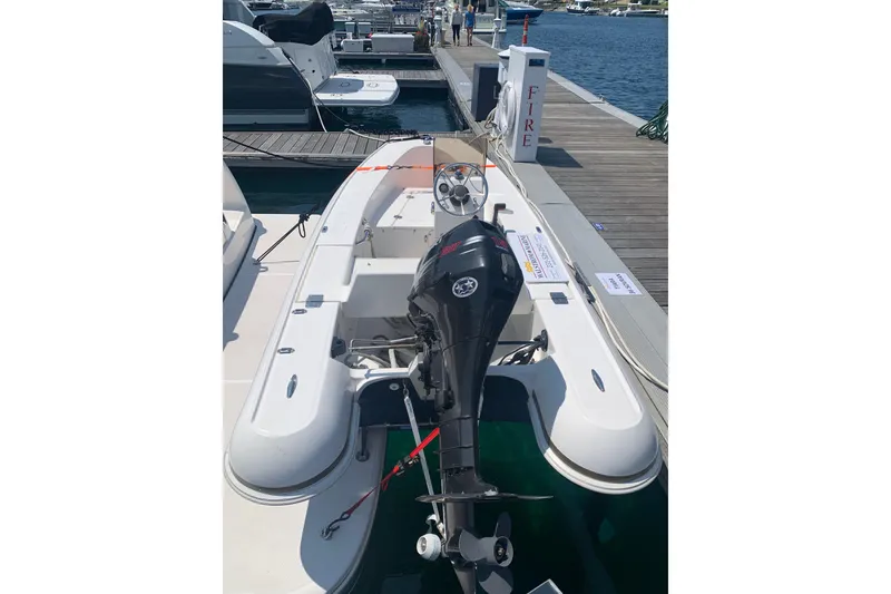 Slide: The Image of 2005 Tiara Yachts 3600 Sovran docked, featuring an outboard motor and sleek design. - 55