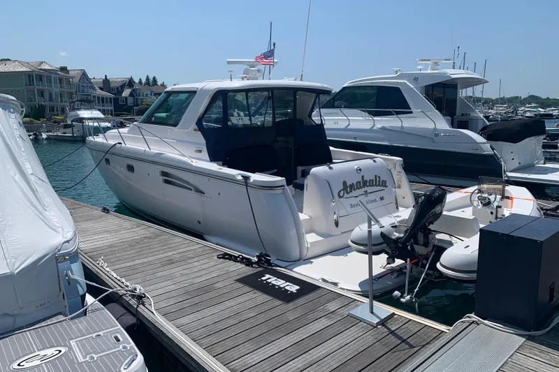 Slide: The Image of 2005 Tiara Yachts 3600 Sovran docked at a scenic marina with waterfront homes. - 6