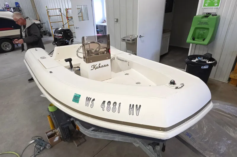 Slide: The Image of 2005 Tiara Yachts 3600 Sovran in a garage, with a Mercury engine visible. - 61