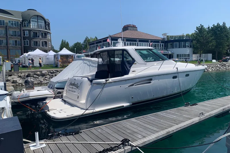 Slide: The Image of 2005 Tiara Yachts 3600 Sovran docked at marina, sunny day, luxury boats in background. - 7