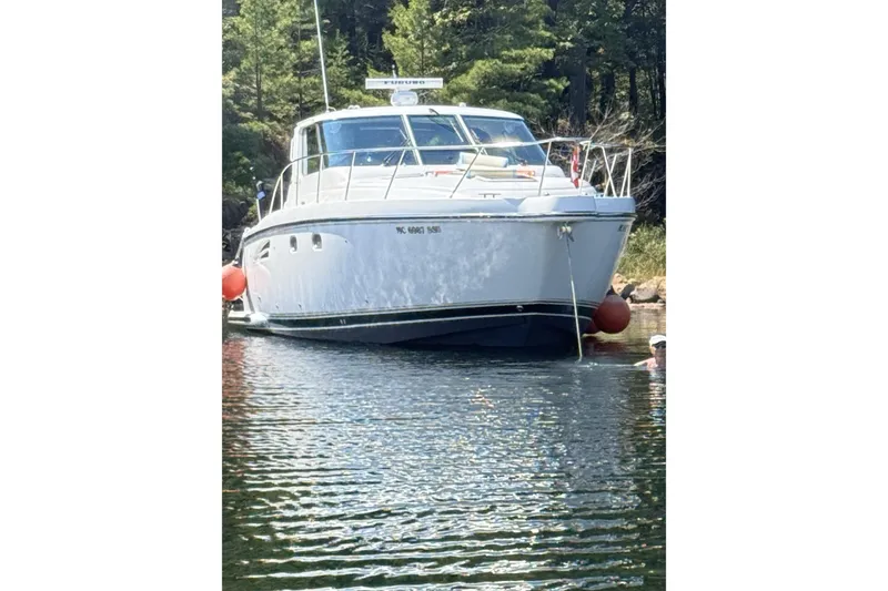 Slide: The Image of 2005 Tiara Yachts 3600 Sovran docked at a marina with waterfront buildings. - 8