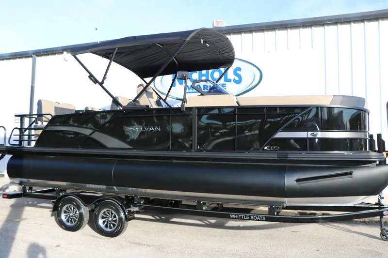 The Image of 2026 Sylvan L3 DLZ pontoon boat with black exterior and canopy, displayed on trailer. - 1