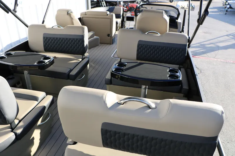 Slide: The Image of Interior of 2026 Sylvan L3 DLZ pontoon boat with beige seating and cup holders. - 18