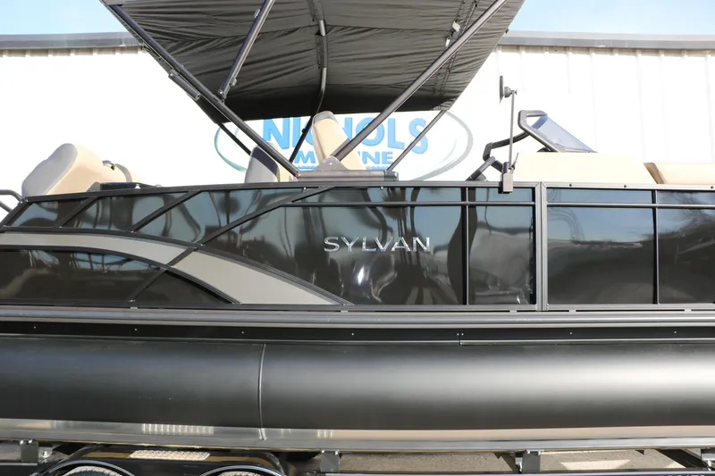 Slide: The Image of 2026 Sylvan L3 DLZ pontoon boat with sleek black exterior and canopy. - 34