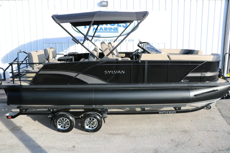 Slide: The Image of 2026 Sylvan L3 DLZ pontoon boat with canopy, parked on a trailer. - 6