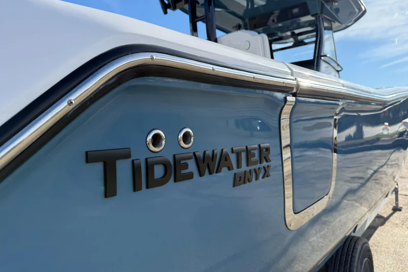 Slide: The Image of 2026 Tidewater 302 CC Adventure boat with Onyx branding, side view. - 10