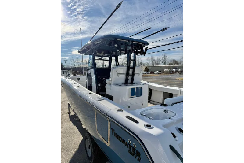 Slide: The Image of 2026 Tidewater 302 CC Adventure boat with sleek design and fishing rods. - 13