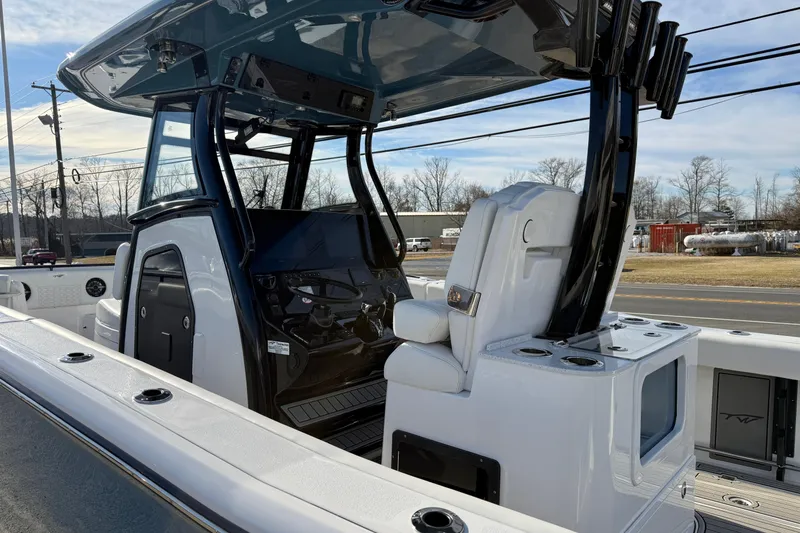 Slide: The Image of 2026 Tidewater 302 CC Adventure boat interior with helm and seating, showcasing modern design. - 15