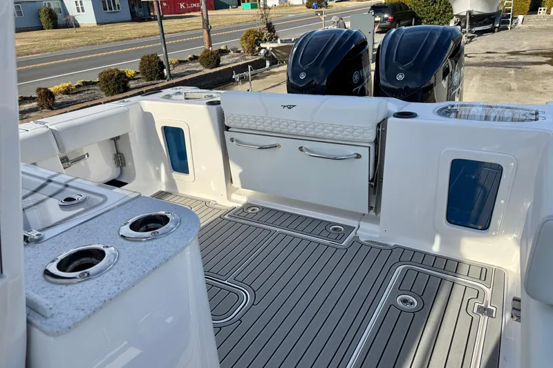 Slide: The Image of 2026 Tidewater 302 CC Adventure boat interior with dual engines and modern deck design. - 17