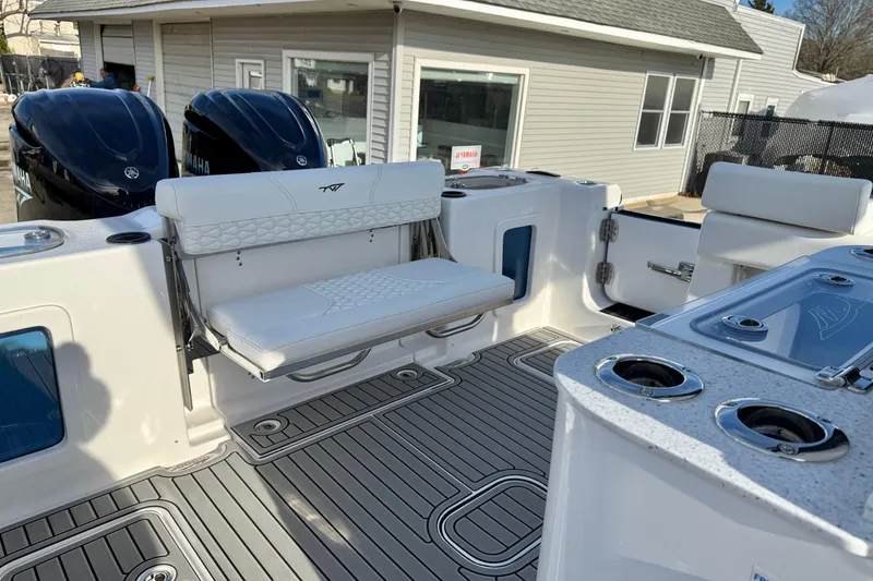 Slide: The Image of 2026 Tidewater 302 CC Adventure boat interior with seating and dual Yamaha engines. - 19