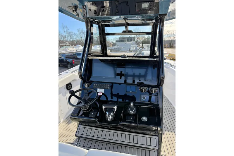 Slide: The Image of 2026 Tidewater 302 CC Adventure boat helm with modern controls and steering wheel. - 22