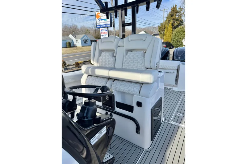 Slide: The Image of 2026 Tidewater 302 CC Adventure boat interior with dual seats and steering wheel. - 23